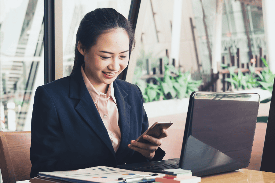 Employee looking at phone while inside office