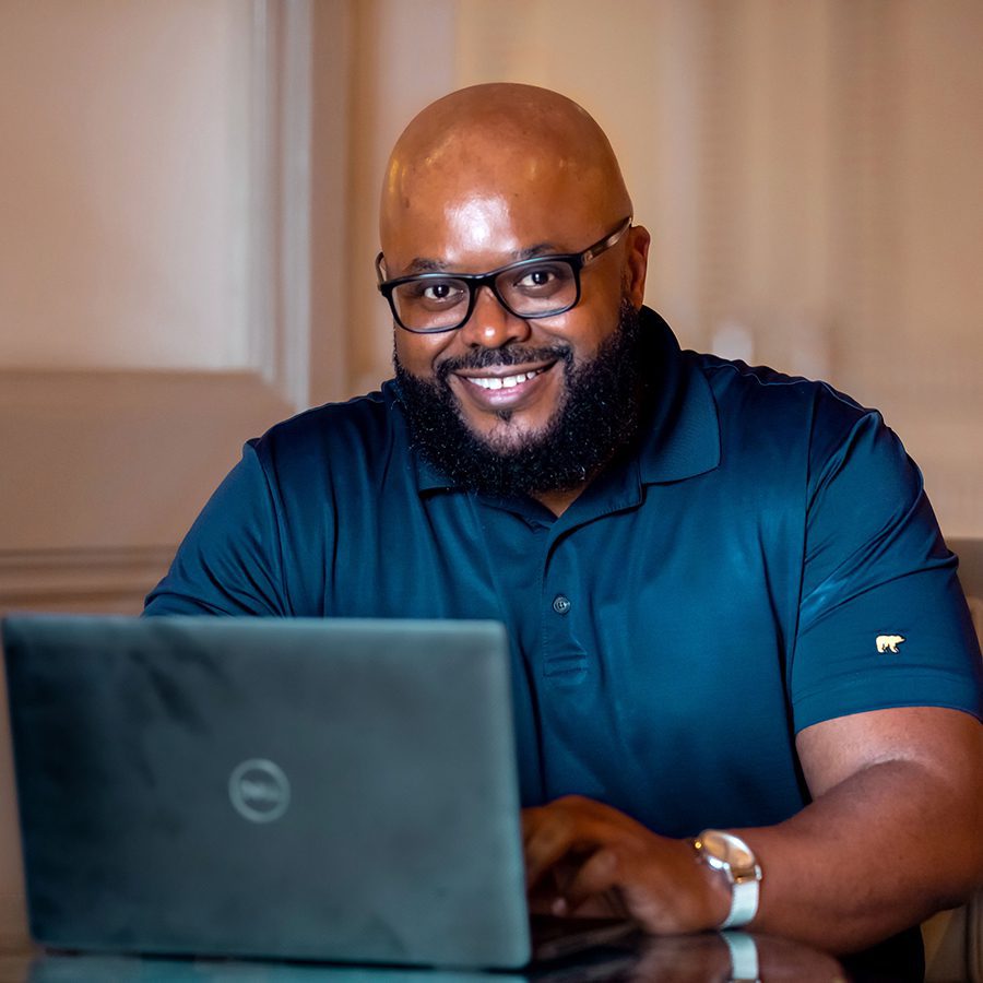 Black man smiling with laptop