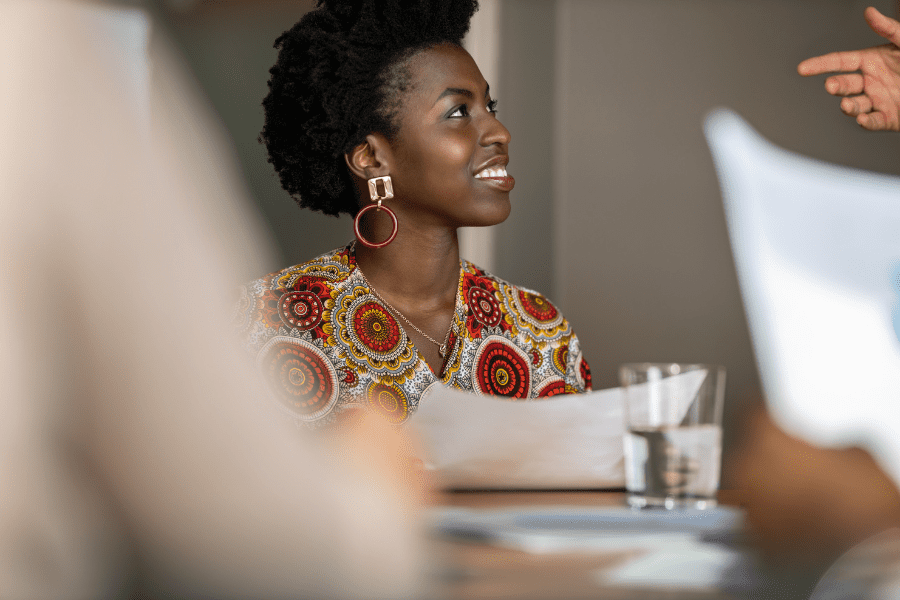 young African business woman smiling in a meeting