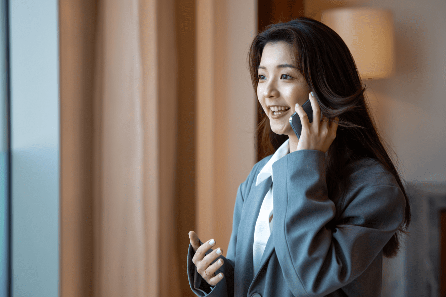 an Asian female employee talking on the phone
