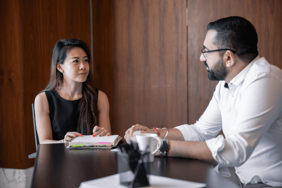 an Asian employee discussing HR matters with a European colleague
