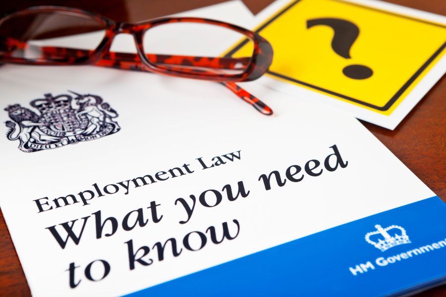 UK's Employment Law guide placed on table with a specs on top of it