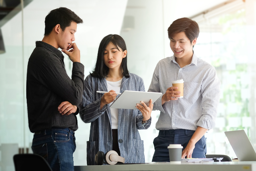 an HR manager explaining employee benefits in China to two new employees