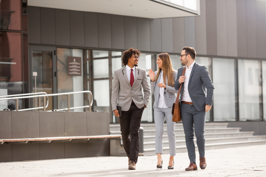 UK employees discussing employee benefits while walking