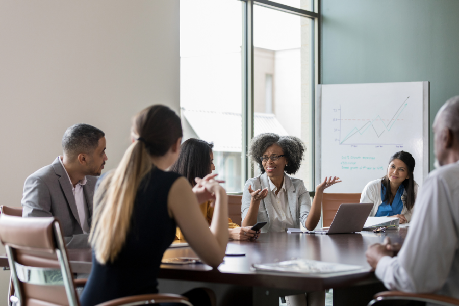 six colleagues sitting in a meeting room