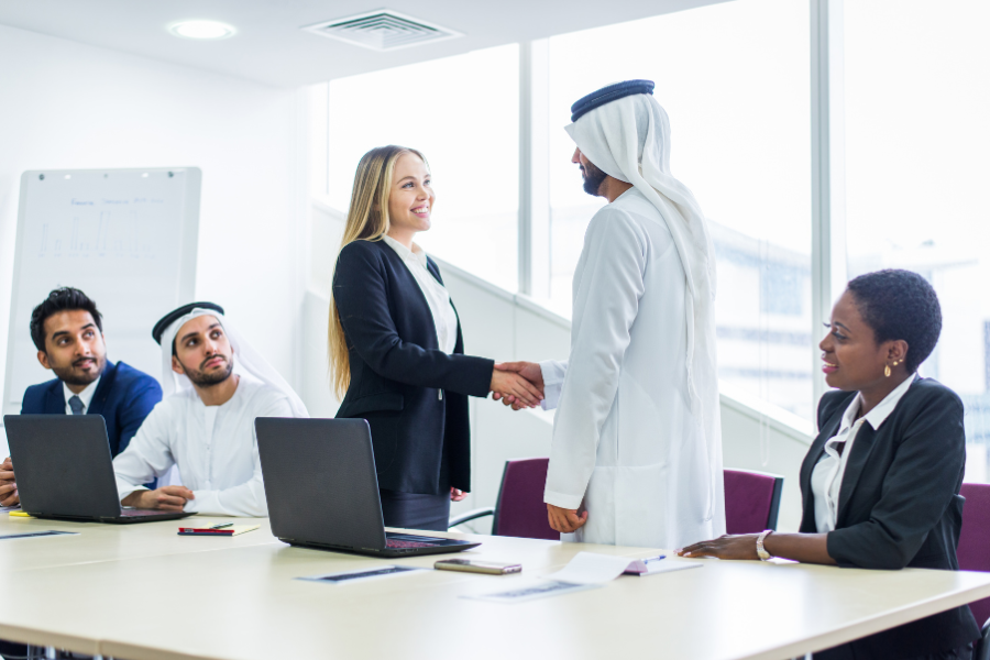 two business partners shaking hands during a business meeting in Dubai