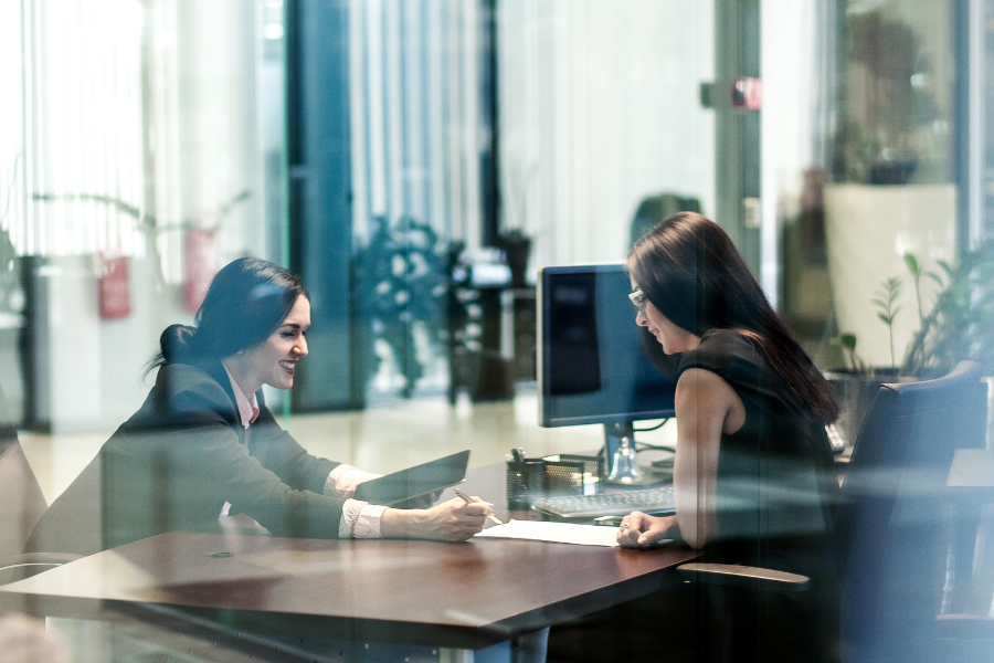 an HR manager discussing employee benefits program with an employee