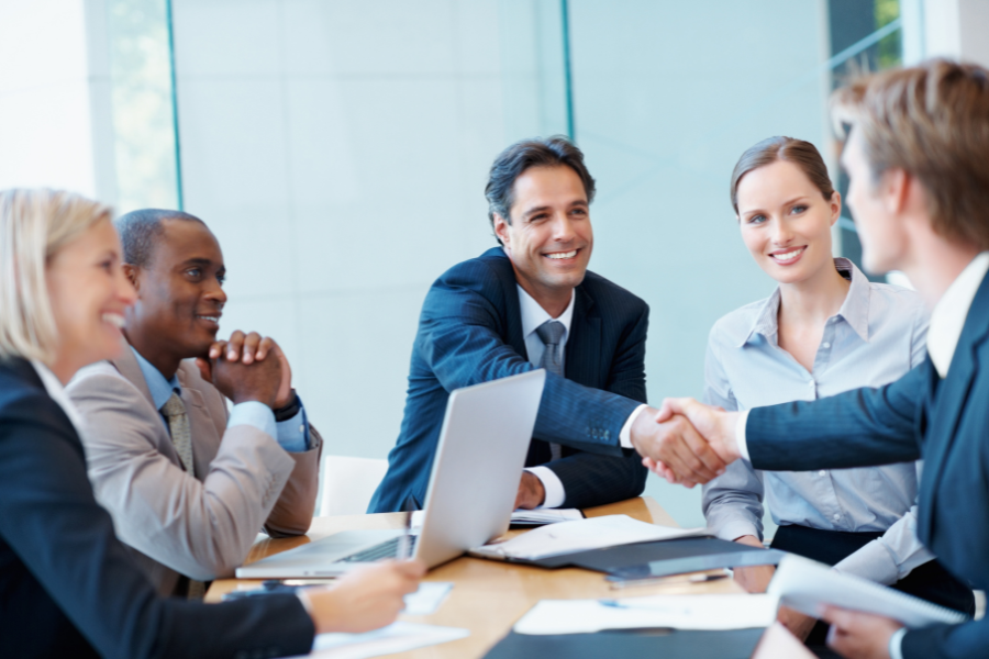 HR manager shaking hands with a partner in a meeting