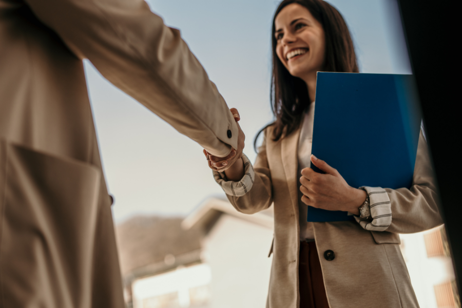 an HR manager shaking hands with a candidate