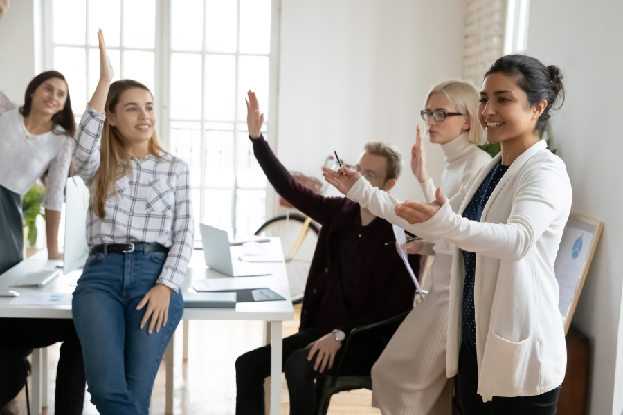 Smiling diverse employees engaged in teambuilding activity at office