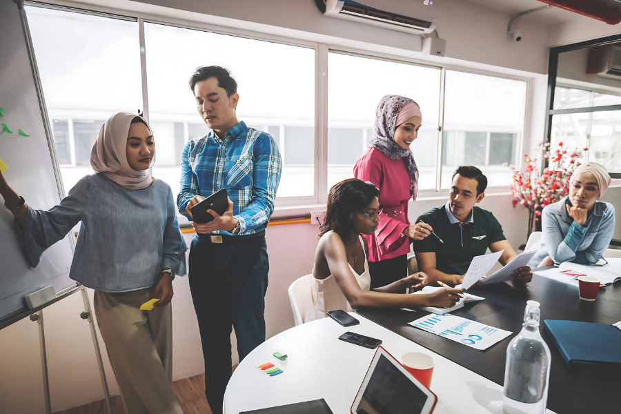 Employees based in Malaysia discussing grants and incentives