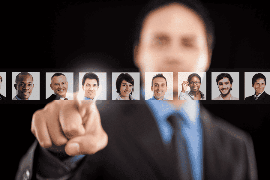 Employer in blurred background choosing the right employee to place with an EOR firm's help