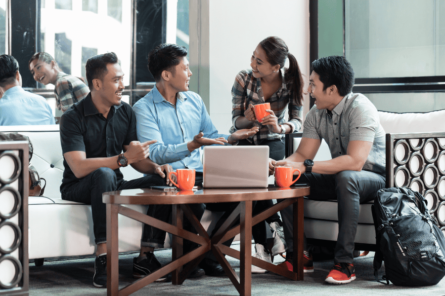 four Philippines colleagues discussing employee benefits