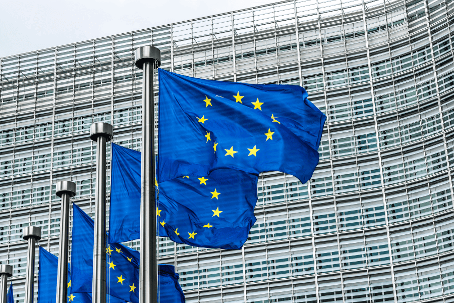 European Union flags flying with a building in the background
