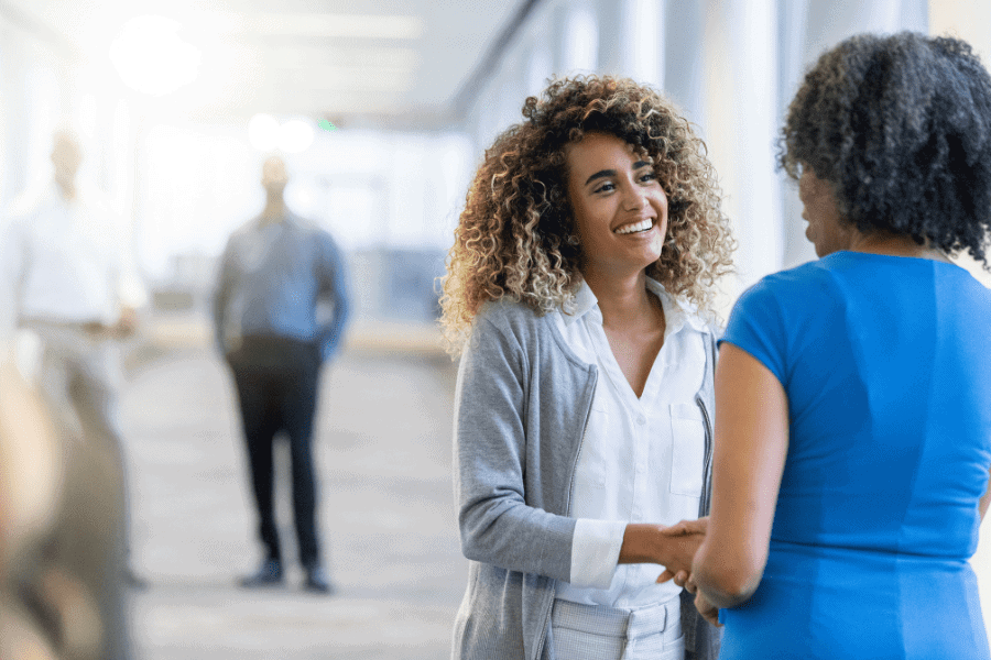 an interview candidate shaking hands with a recruiting manager