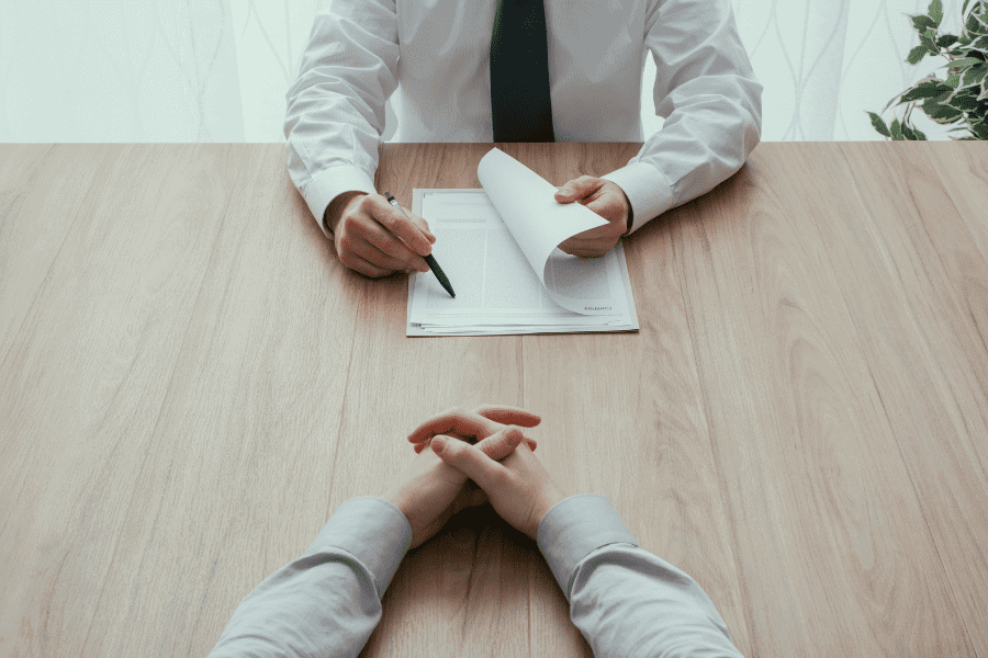 point of view shot of a global hiring manager reading a resume during a job interview