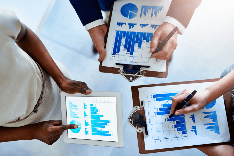 business people holding charts and graphs