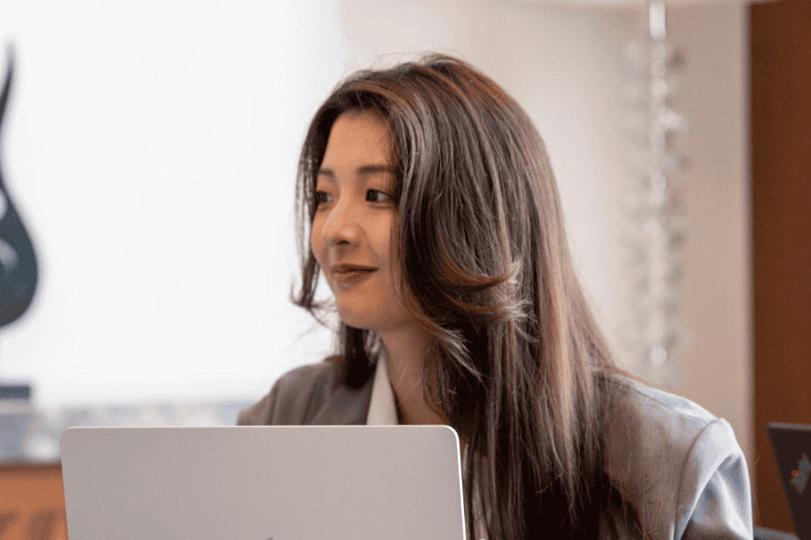 a female Asian employee smiling