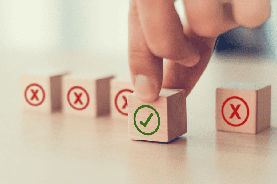 five wooden blocks with checkmark and cross signs