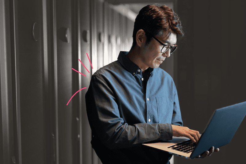Asian man holding a laptop