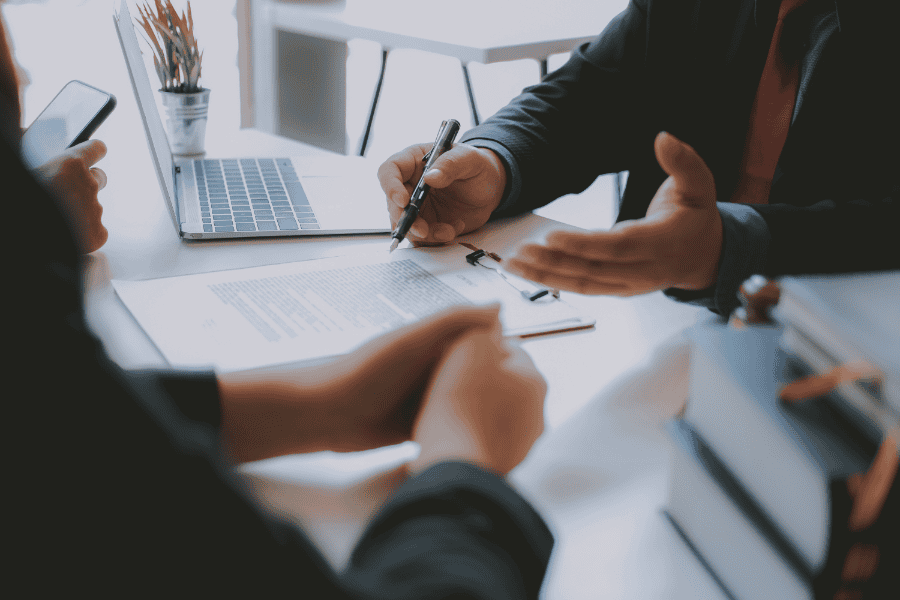 Business executive holding a pen to sign the corporate bank account form.