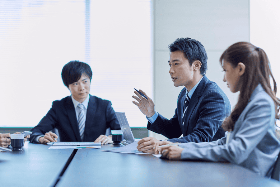 three professionals discussing entity setup in Japan