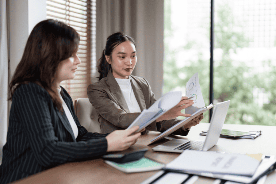 two female colleagues working together at a desk
