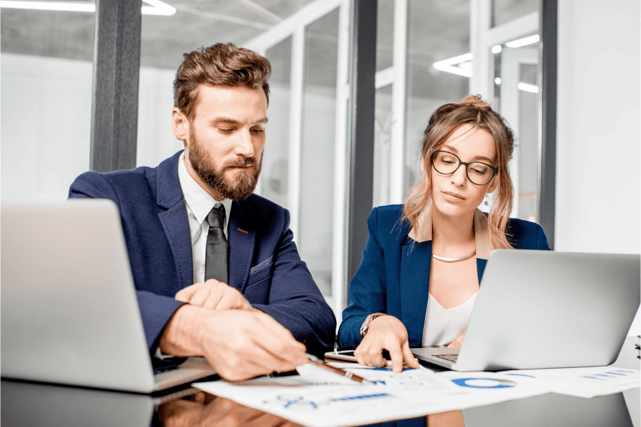 two business managers looking at reports