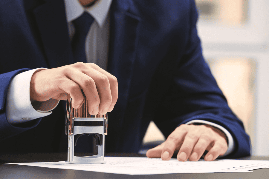 Bank executive stamping the account opening form.