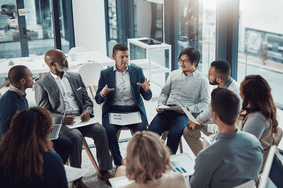 a diverse group of professionals sitting in a circle and engaging in a discussion