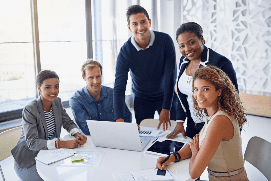 five colleagues at a table in an office