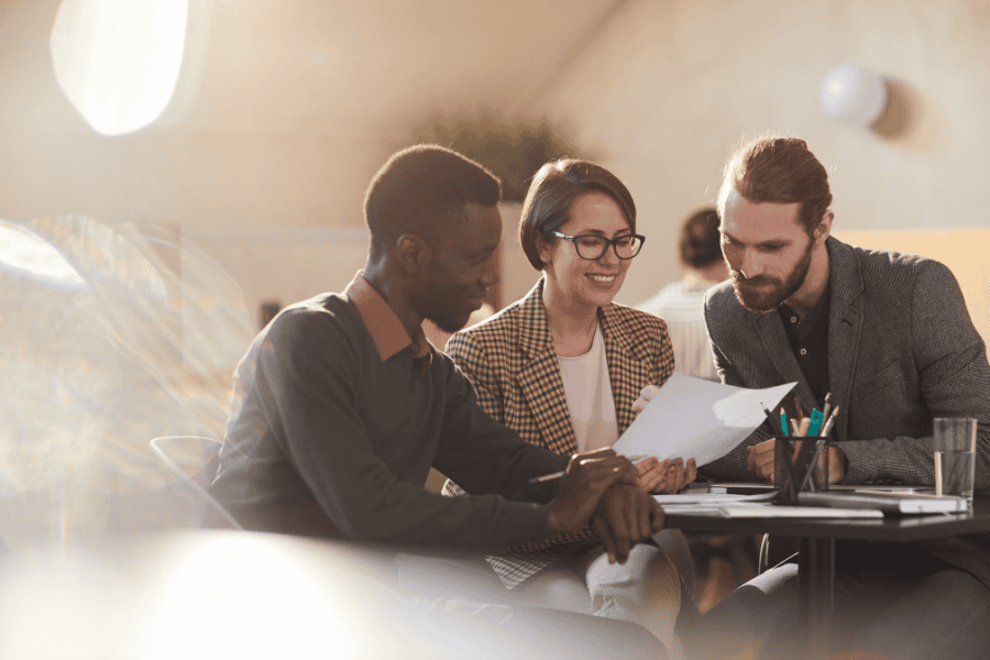 three colleagues looking at paperworks together