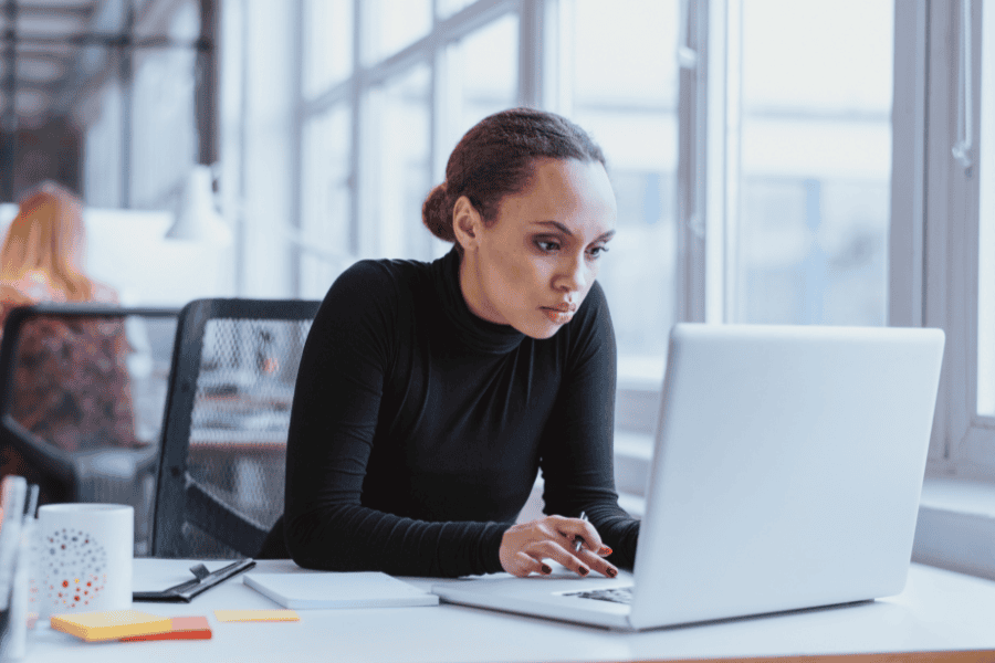 a female employee working on a laptop in an office