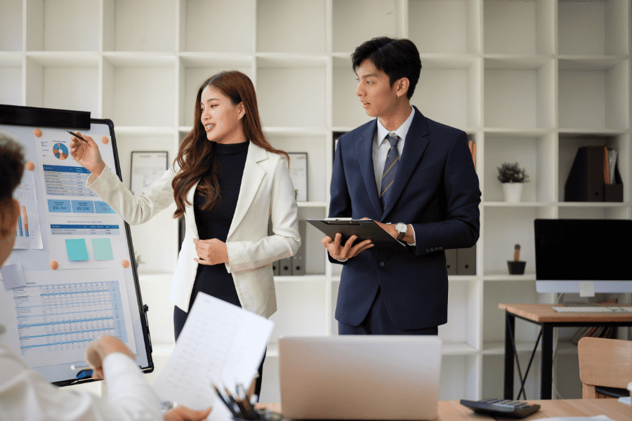 A female colleague leading a meeting in office.