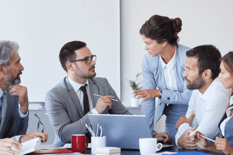 five colleagues discussing M&A issue in a meeting room