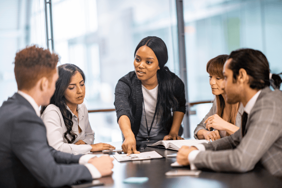five colleagues discussing Germany business structure in a meeting room