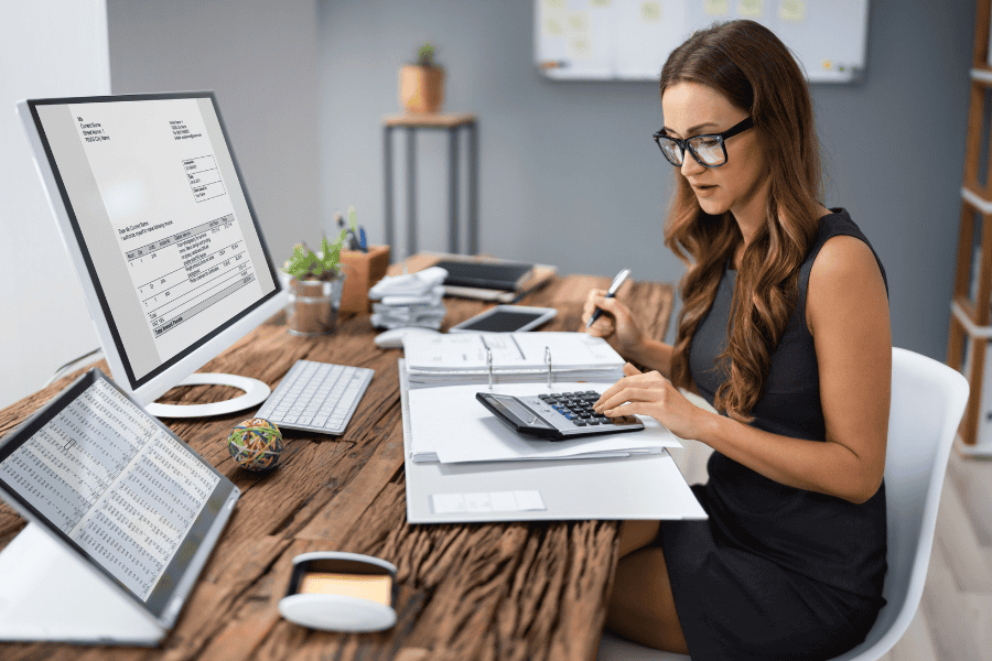 a woman professional calculating German tax at her desk