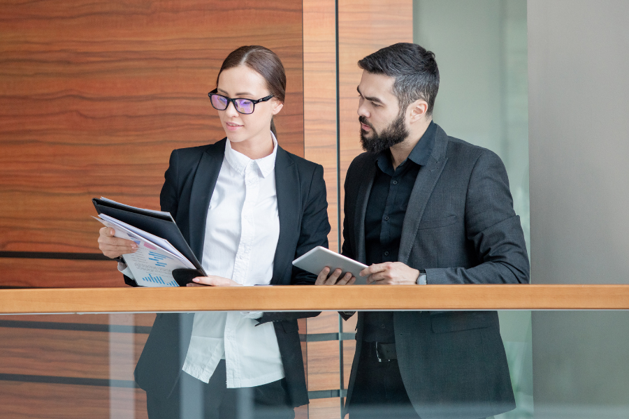 a professional woman and man reviewing bank documents