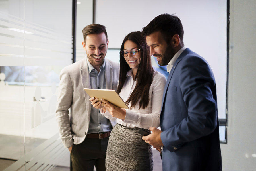 three colleagues looking at a tablet