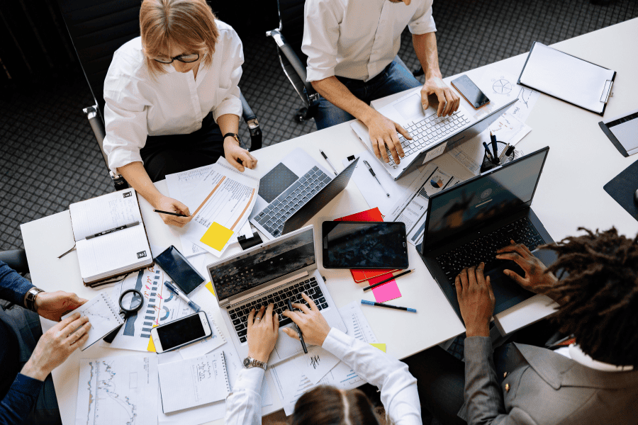 five colleagues working at a table together