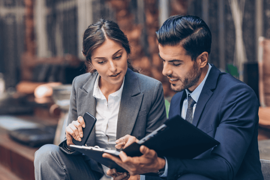 two colleagues reviewing expansion plan document