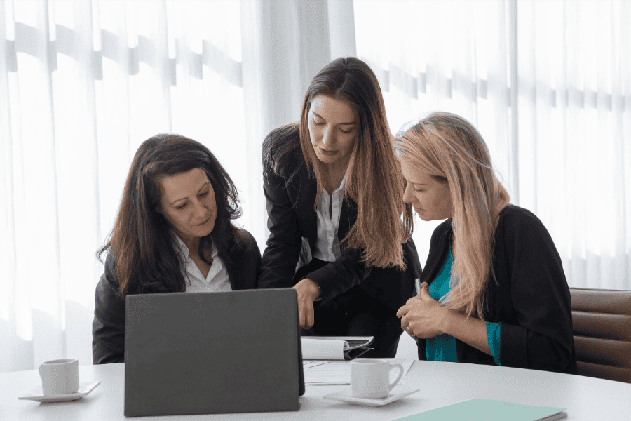 Three professional women reviewing entity setup and global expansion strategies.