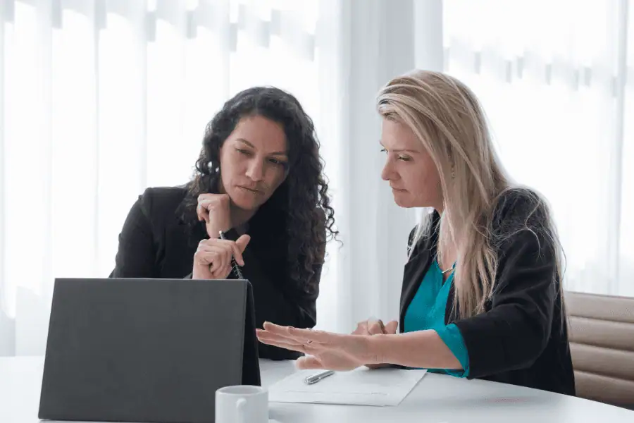 a CFO and colleague reviewing payroll documents