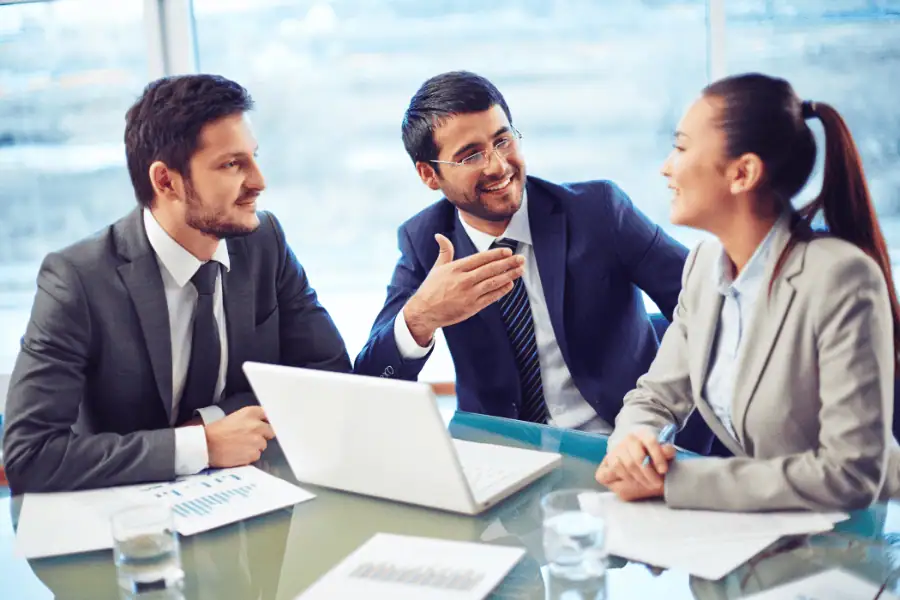 three colleagues discussing workforce transition for a global tech M&A