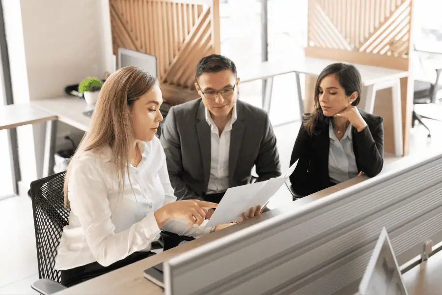 three colleagues analyzing employment structure for the US market