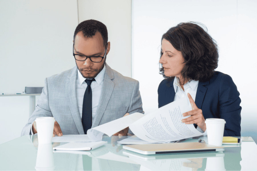 2 professionals checking EU pay transparency directive guide.