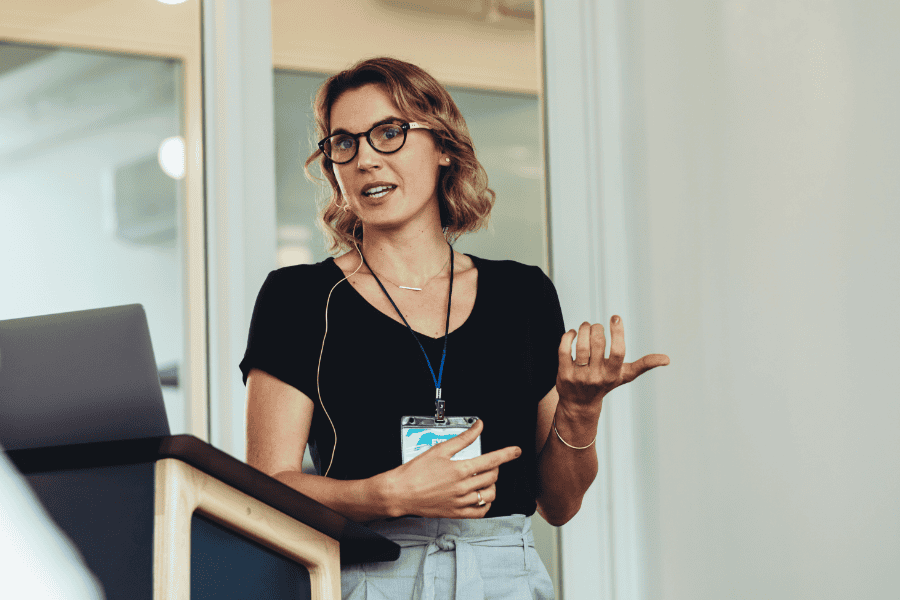 Businesswoman giving a presentation at a conference on international markets.