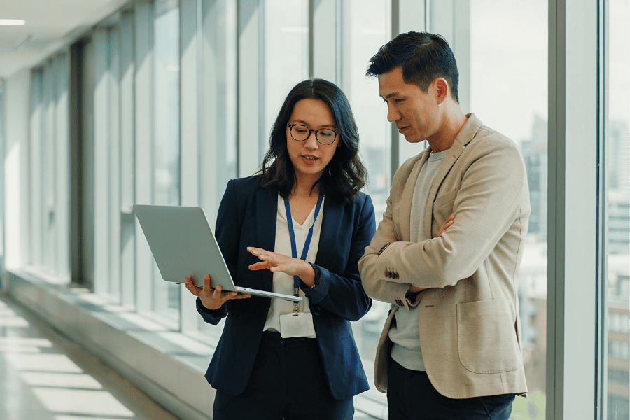 Business professionals discussing strategies in a modern office setting.