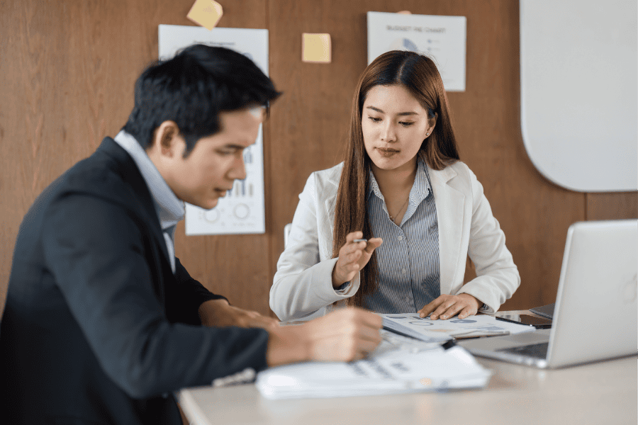 Business professionals discussing China market entry options at a meeting.