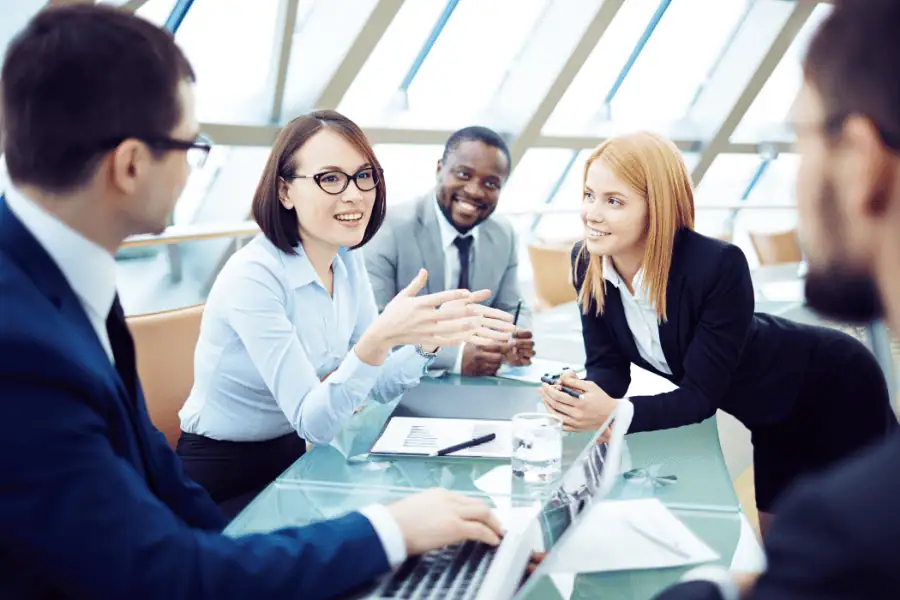 Diverse team discussing EOR to entity transition strategies in a modern office.